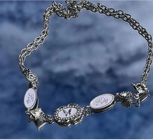 Detail view of double-layered Y2K choker with crystal butterfly pendant and Risy charms