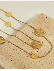 Detail of vintage gold plated titanium steel necklace with diamond-set round charms