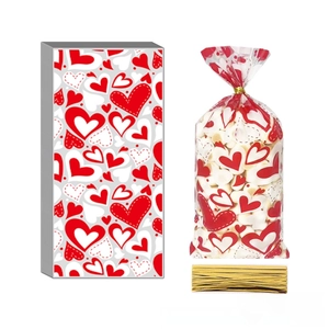 Detail of red heart pattern candy bags with gold twist ties for Valentine's Day party favors
