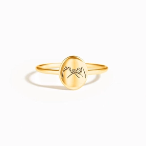 Detail of s925 sterling silver pinky swear promise ring with engraved oval seal signet