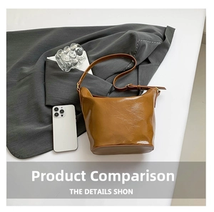 Detail shot of brown wax-texture bucket bag with adjustable strap and glossy finish