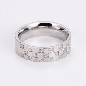 Detailed view of silver checkerboard ring with small diamonds and polished finish