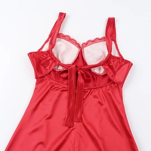 Detail of red satin dress featuring delicate lace trim and elegant back lace-up design