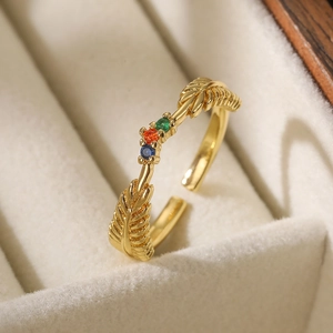 Detailed macro view of gold-plated feather ring with vibrant multicolor zircon stones