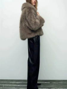 Deep brown faux fur jacket paired with glossy black leather wide-leg pants on a model