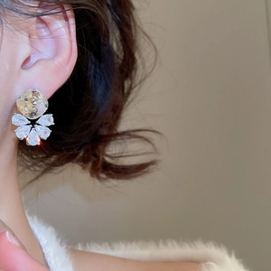 Close-up of zircon teardrop earrings showing cubic zirconia stones and silver needle studs