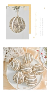 Detail of gold sequined Christmas ball with white pearl beads and elegant hanging string