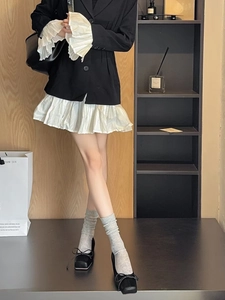 Detail of grey vertical striped socks with black square toe bow flats and pleated hem dress