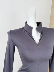 Detail of slim fit dark grey long sleeve sports top with high neck zipper closure