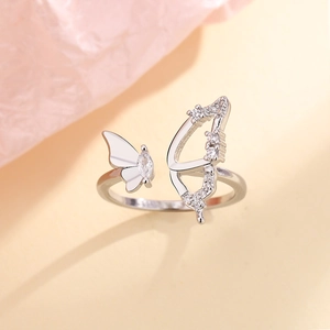 Macro detail of silver butterfly ring with hollow zircon wings and sparkling marquise stone