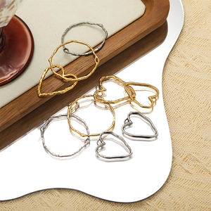 Polished stainless steel heart and irregular geometric charms in gold and silver finish