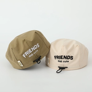 Detail of adjustable elastic drawstring and friends embroidery on canvas beret hat