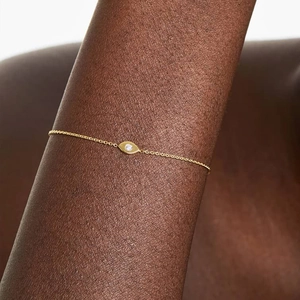 Detailed view of an S925 silver gold-plated evil eye bracelet worn on a female wrist