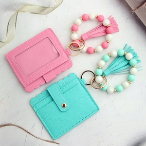 Detailed macro view of litchi pattern PU leather card holder with silicone bead wristlet