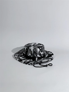 Detail of camouflage outdoor boonie hat with breathable metal eyelets and chin strap
