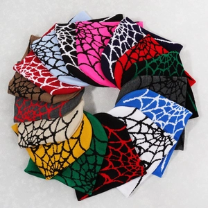Flat lay of colorful spider web knit beanies showing a wide range of vibrant color options