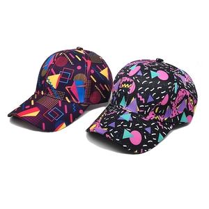 Detail of two baseball caps featuring colorful geometric patterns on purple and black fabric