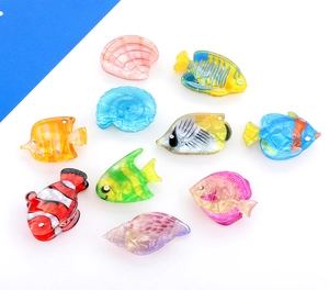 Detail of colorful acrylic ocean-themed hair clips featuring fish and shell designs