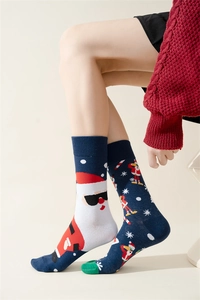 Detail of navy blue Christmas socks featuring Santa Claus and snowflake knitted patterns
