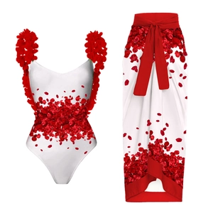 Detail showing white one-piece swimsuit and matching sarong with red floral appliques