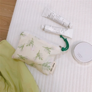 Floral cotton pouch detail showing green leaf patterns and simple wish fabric label