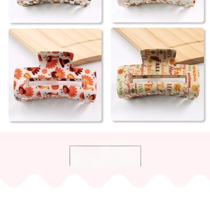 Detail of rectangular hair claw clips with turkey and fall maple leaf festive patterns