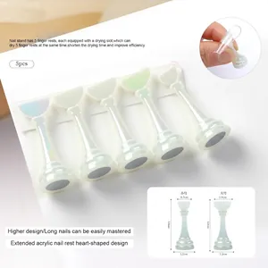 Macro detail of acrylic nail tip holders with heart top and magnetic base for practice