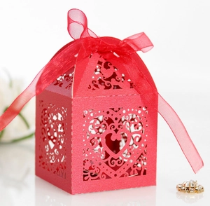 Detailed laser cut red heart hollow candy box with matching organza ribbon for weddings