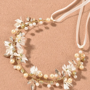 Elegant bridal hair vine with white fabric flowers, pearls and golden leaves on ribbon