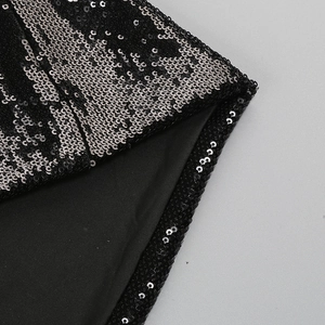 Macro shot of silver sequins on black fabric with high-quality stitching detail