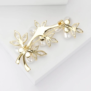 Golden tree vine brooch with pearls and cubic zirconia shown from the back view