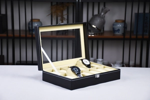 Detail view of 10-slot black leather watch box with clear glass lid and soft beige cushions