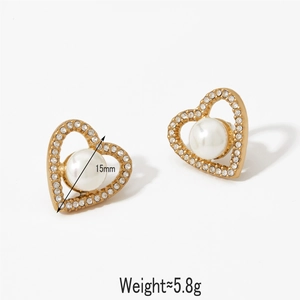 Elegant gold heart earrings with white pearls and rhinestones on white background