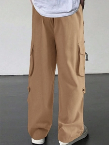 Detail view of multi-pocket design on dark khaki parachute cargo pants for men