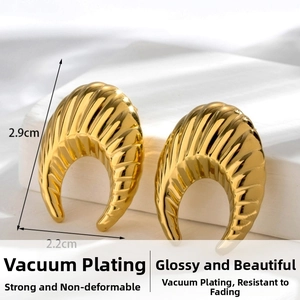 Detail view of gold C-shape twisted hoop earrings with dimensions 2.9cm by 2.2cm