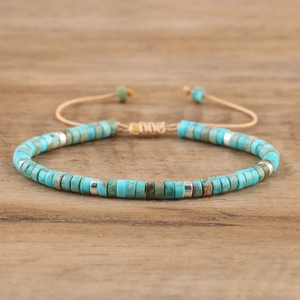 Macro shot of turquoise stone beads with silver spacers on adjustable woven rope bracelet