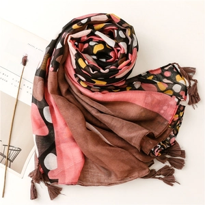 Detail of colorful geometric circle print shawl with brown tassel fringe and soft texture