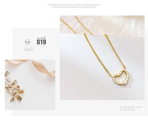Detailed view of a gold-plated heart pendant necklace featuring sparkling zircon stones