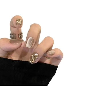 Champagne cat-eye press-on nails with sparkling rhinestones and nude milk tea tones