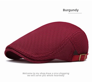 Detail of burgundy mesh beret cap showing breathable texture and adjustable metal buckle