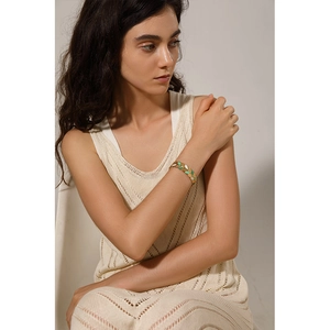 Elegant gold-plated stainless steel leaf bracelet with light green and white enamel details