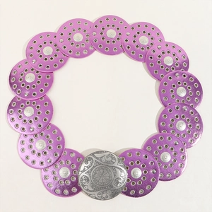 Detail of purple metal disk belt with vintage engraved silver buckle for dresses
