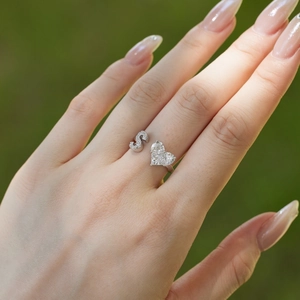 Detailed close-up of S925 sterling silver open ring with S-letter and heart zircon on finger