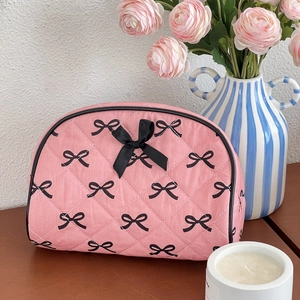 Pink quilted makeup bag with black bow patterns and large capacity storage