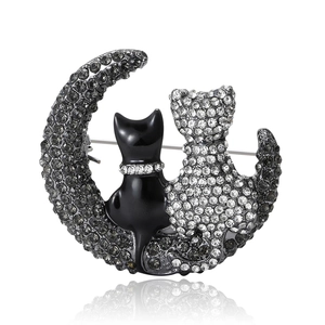 Elegant cat and crescent moon brooch with grey rhinestones and black finish