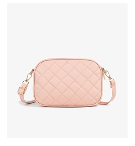 Close-up of pink quilted faux leather camera bag with gold hardware and zippers