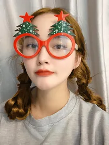 Close-up of festive Christmas tree glasses frame with red star decor for party cosplay