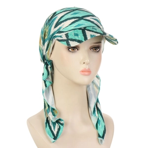 Detail of teal and yellow geometric pattern on a stylish tied turban sun hat