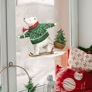 Christmas window sticker featuring a polar bear skiing on glass with winter decor