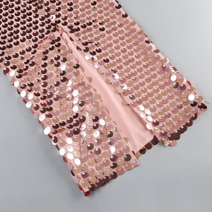 Close-up of pink sequin dress showing detailed metallic texture and satin lining